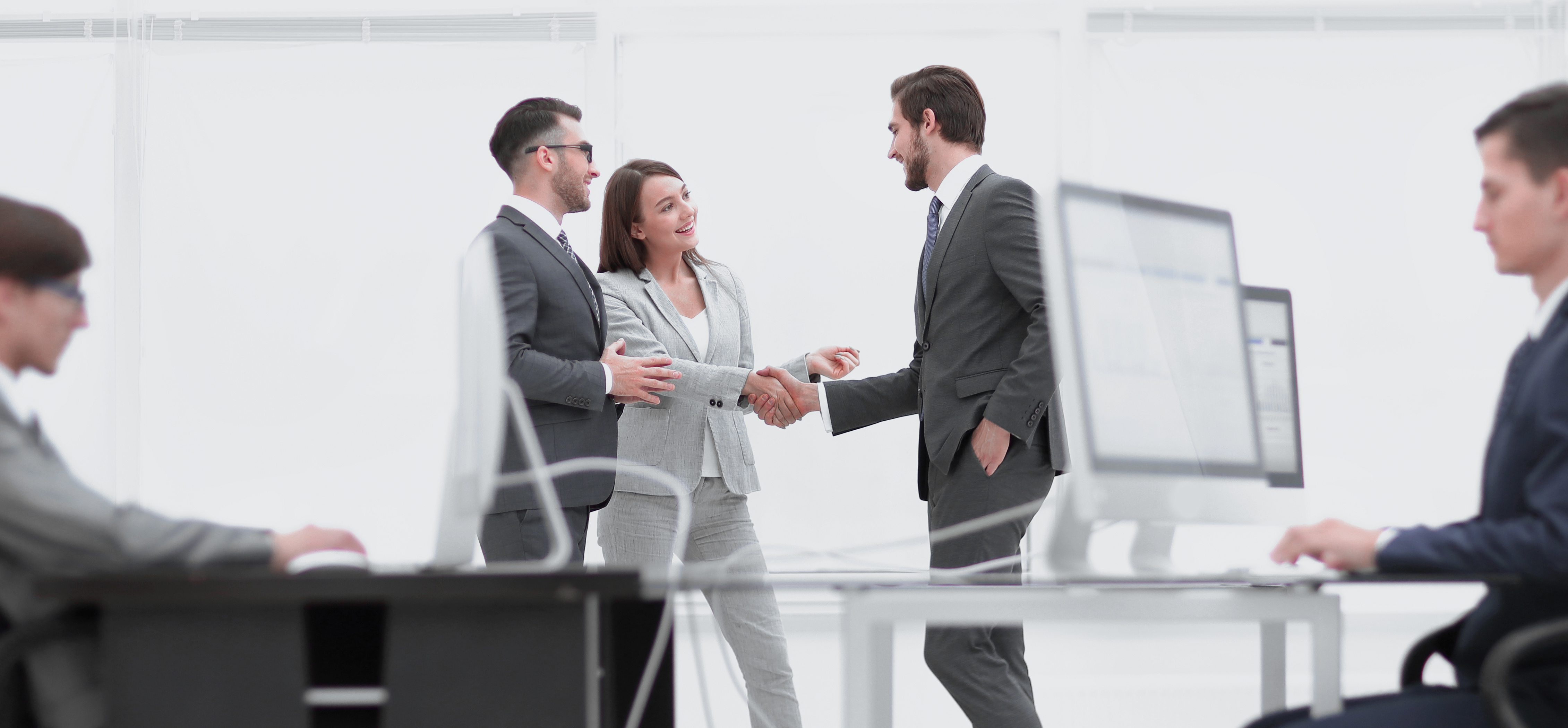 Salesmen and buyer discuss the contract Businessman signing contract while his partner is looking at him in cosy meeting room